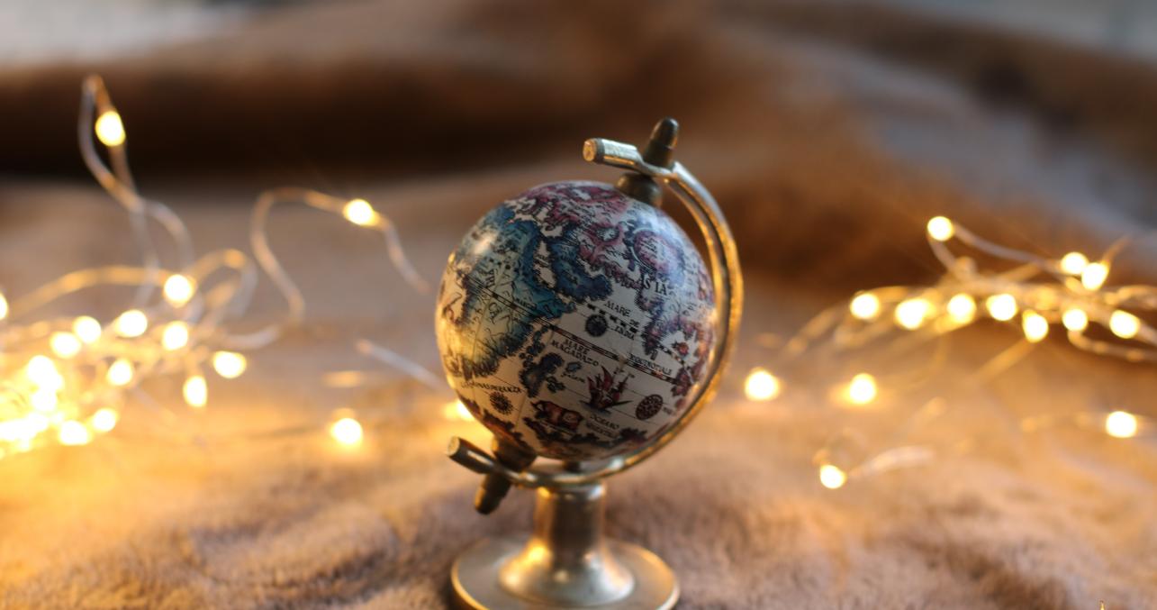 small earth globe surrounded by fairy lights
